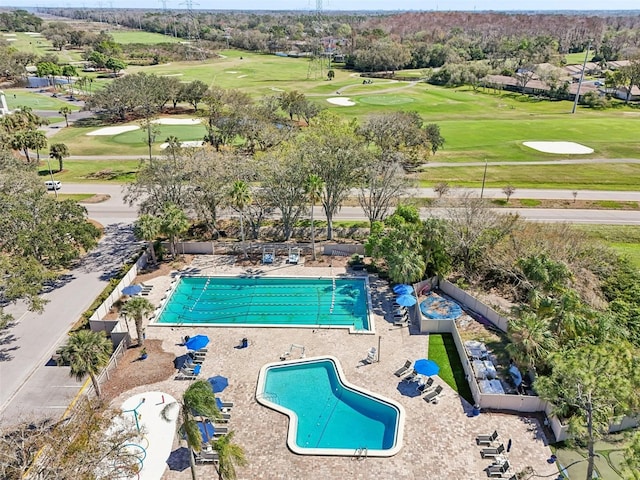 view of swimming pool featuring golf course view
