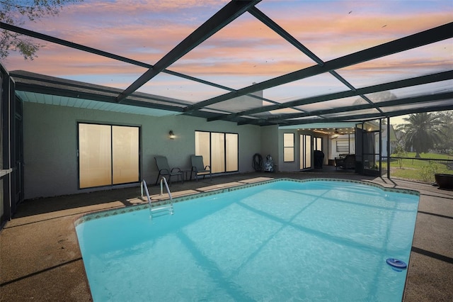 pool at dusk with a patio area, an outdoor pool, and a lanai