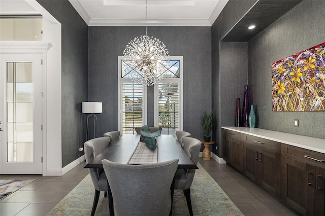 dining space featuring wallpapered walls, baseboards, a chandelier, and ornamental molding