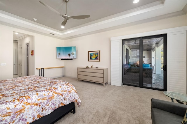 bedroom with ornamental molding, access to outside, a tray ceiling, and light colored carpet