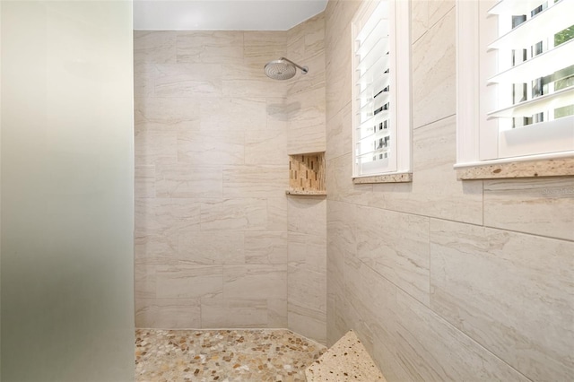 full bath with a tile shower