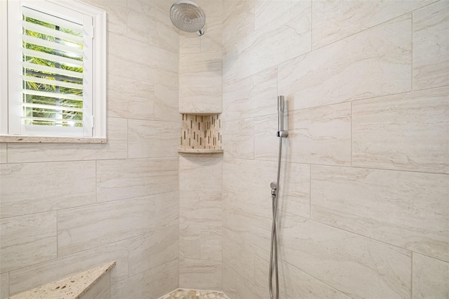 bathroom with a tile shower