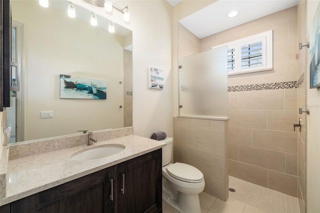 bathroom with toilet, a walk in shower, and vanity