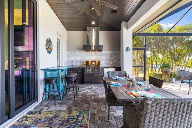 exterior space featuring brick floor, backsplash, wood ceiling, wall chimney exhaust hood, and fridge