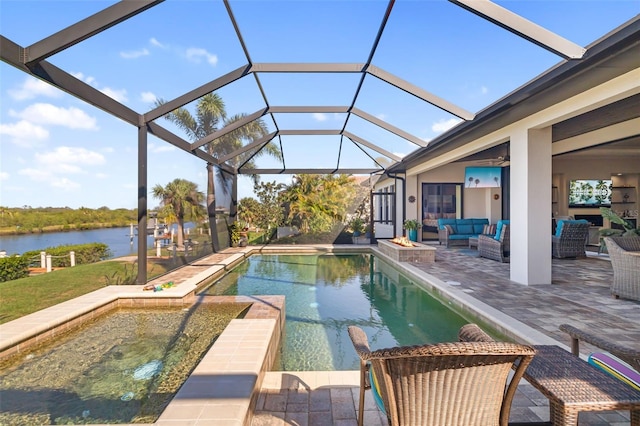 outdoor pool featuring a patio area, glass enclosure, outdoor lounge area, and a water view