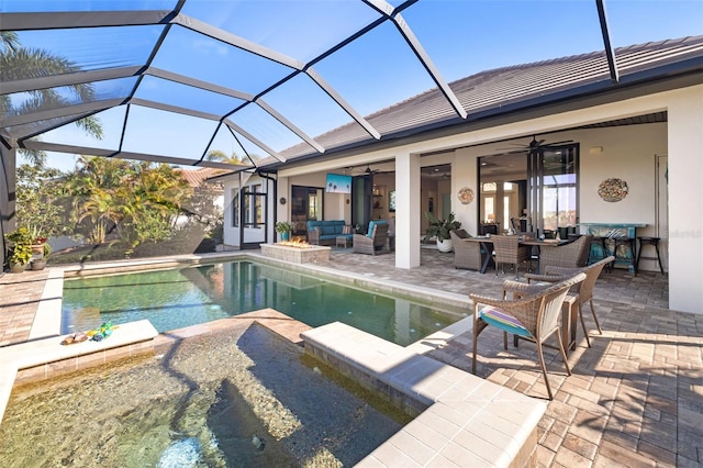 view of pool featuring a patio, ceiling fan, an outdoor hangout area, a lanai, and a pool with connected hot tub