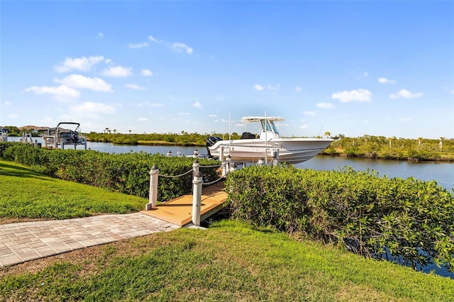 dock area with a water view and a lawn