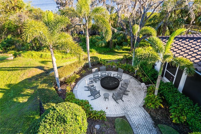 exterior space featuring a fire pit, a lawn, and a patio area