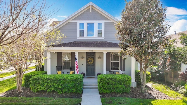 view of front of property featuring covered porch and a shingled roof