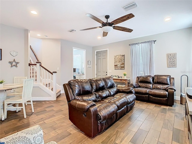 living area with stairs, recessed lighting, visible vents, and wood tiled floor