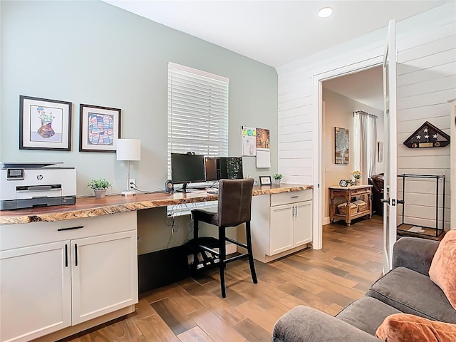 office featuring light wood finished floors and built in desk