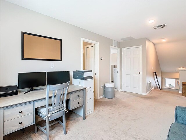 office space with visible vents, light colored carpet, and baseboards