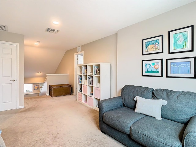 living area with visible vents, an upstairs landing, lofted ceiling, carpet floors, and baseboards