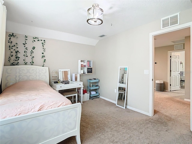 carpeted bedroom with visible vents, baseboards, and lofted ceiling