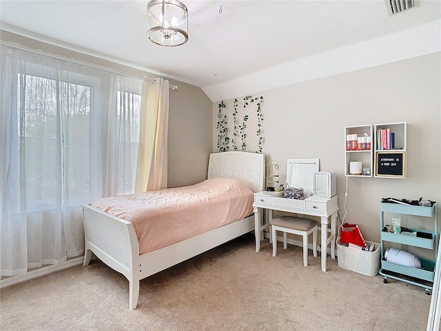 carpeted bedroom featuring vaulted ceiling, visible vents, and a chandelier