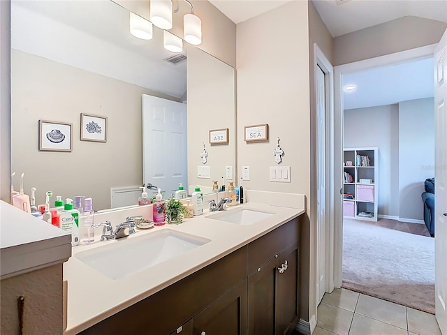 full bathroom featuring double vanity, visible vents, tile patterned floors, and a sink