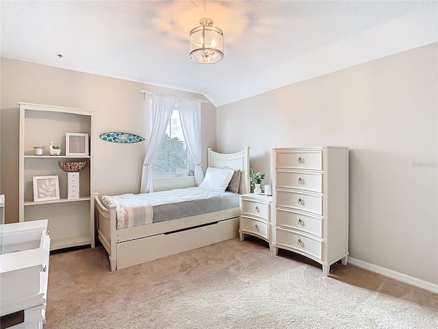 bedroom with baseboards, light carpet, a notable chandelier, and vaulted ceiling