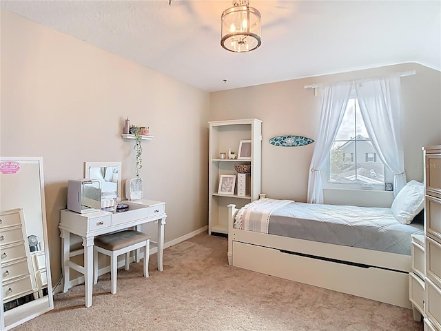 bedroom with baseboards, light carpet, and an inviting chandelier