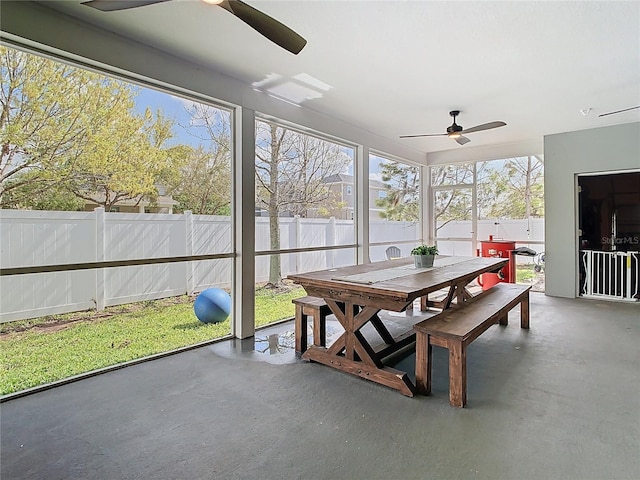 sunroom / solarium featuring ceiling fan