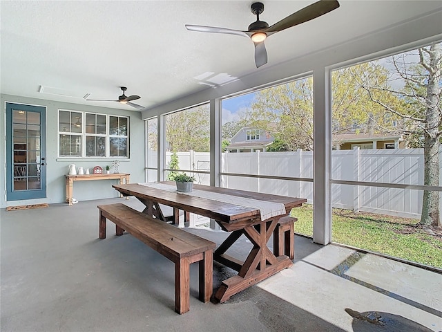 sunroom / solarium with a ceiling fan