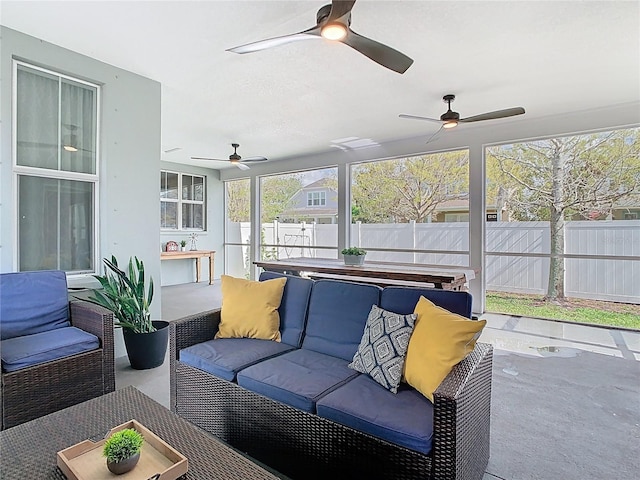 sunroom / solarium with a ceiling fan