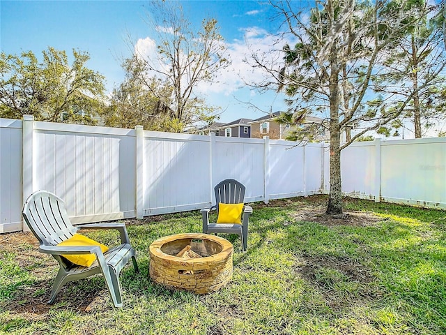 view of yard featuring a fire pit and a fenced backyard