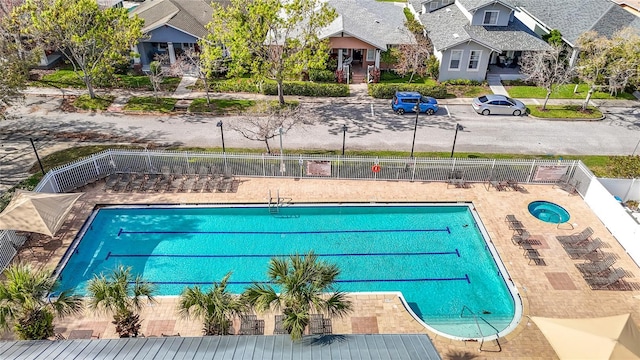 pool with a patio and fence