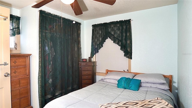 bedroom featuring a textured ceiling and a ceiling fan