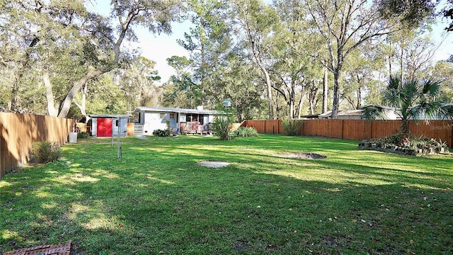 view of yard featuring a fenced backyard and an outdoor structure