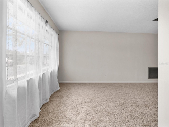 carpeted empty room with baseboards and visible vents