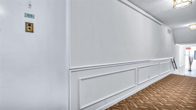 855 Bayway Blvd Unit 105, Clearwater, FL 33767 - hall with a textured ceiling and wainscoting