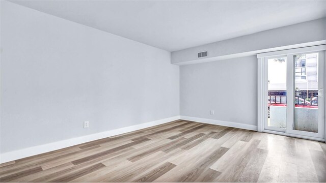 855 Bayway Blvd Unit 105, Clearwater, FL 33767 - empty room with wood finished floors and baseboards