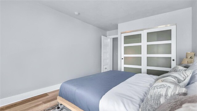 855 Bayway Blvd Unit 105, Clearwater, FL 33767 - bedroom with wood finished floors and baseboards