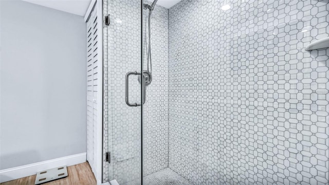 855 Bayway Blvd Unit 105, Clearwater, FL 33767 - bathroom view of a stall shower, baseboards, and wood finished floors