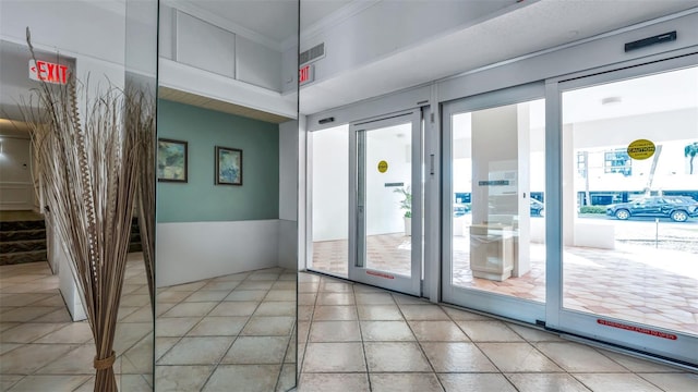 855 Bayway Blvd Unit 105, Clearwater, FL 33767 - entryway featuring light tile patterned floors and ornamental molding