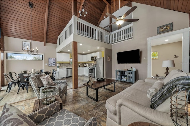 living room with beam ceiling, wood ceiling, stone finish floor, high vaulted ceiling, and ceiling fan with notable chandelier