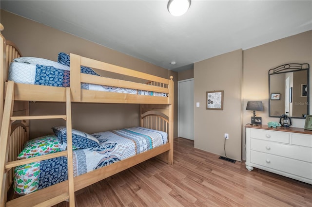 bedroom with visible vents and wood finished floors