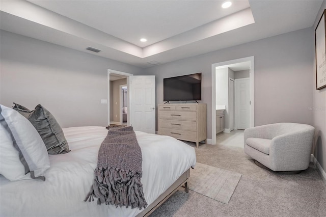 bedroom featuring recessed lighting, a raised ceiling, visible vents, light carpet, and baseboards