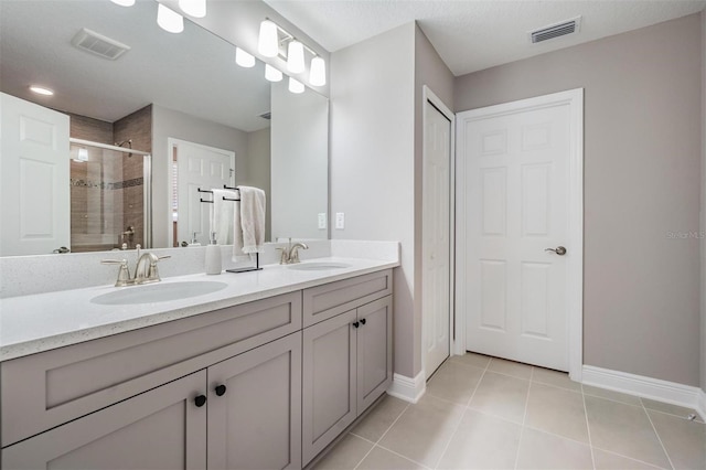 full bath featuring visible vents, a sink, and tile patterned floors