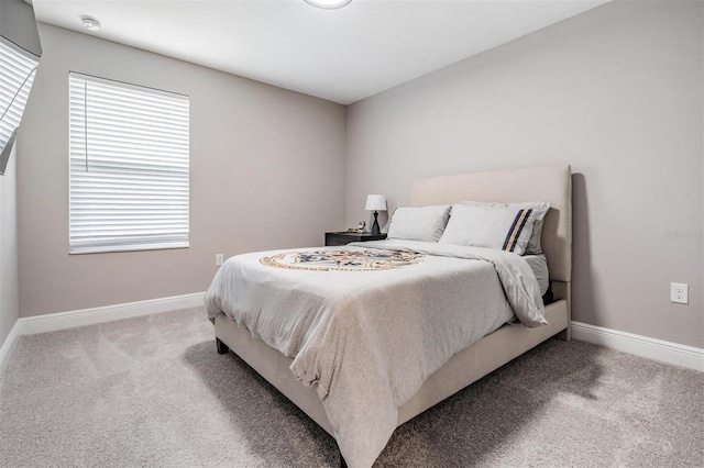 bedroom with carpet floors and baseboards