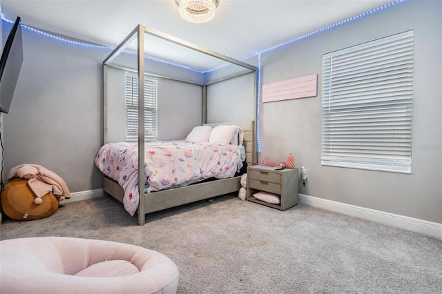 carpeted bedroom with baseboards