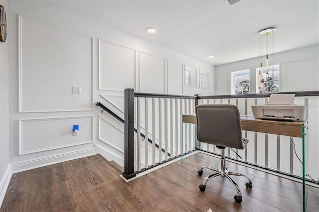 office area featuring wood finished floors and a decorative wall