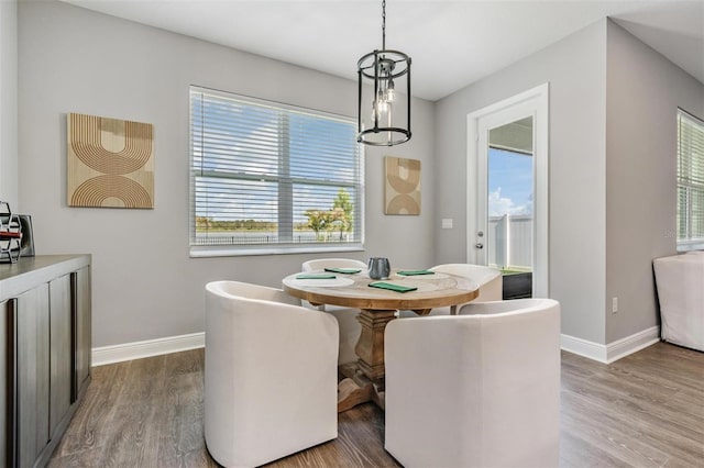 dining room featuring baseboards and wood finished floors