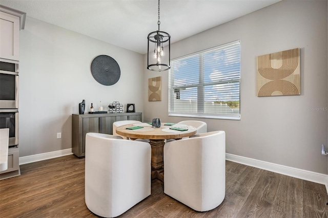 dining area featuring dark wood finished floors and baseboards