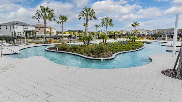 pool with fence and a residential view