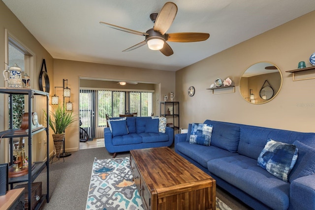 carpeted living room featuring a ceiling fan