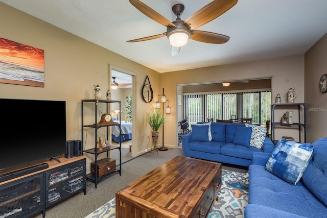 living area featuring carpet floors, ceiling fan, and baseboards