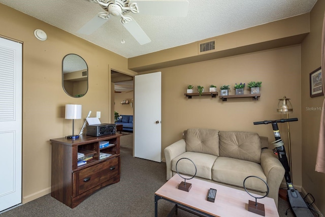 living area featuring a textured ceiling, ceiling fan, dark carpet, and visible vents