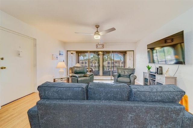 living room with ceiling fan and wood finished floors