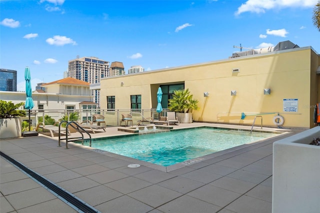 view of swimming pool with a pool with connected hot tub and a patio